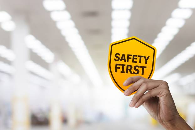 Hand,Holding,Safety,First,Symbols,For,Work,Safety,,Safety,First