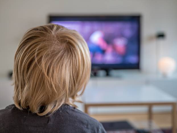 A,Little,Boy,Watching,Tv,At,Home.,View,From,Behind