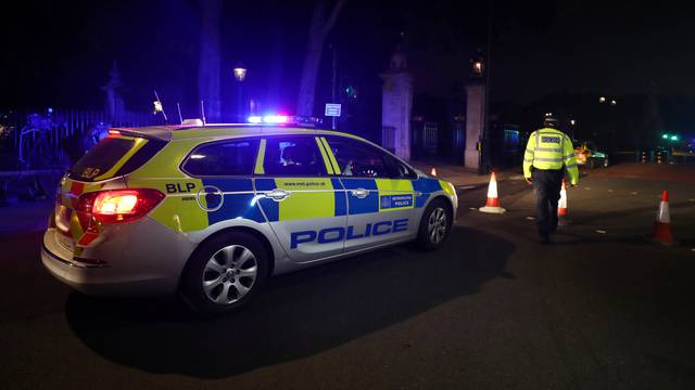 A police officer stands at a cordon after police arrested a man carrying a knife outside Buckingham Palace in London