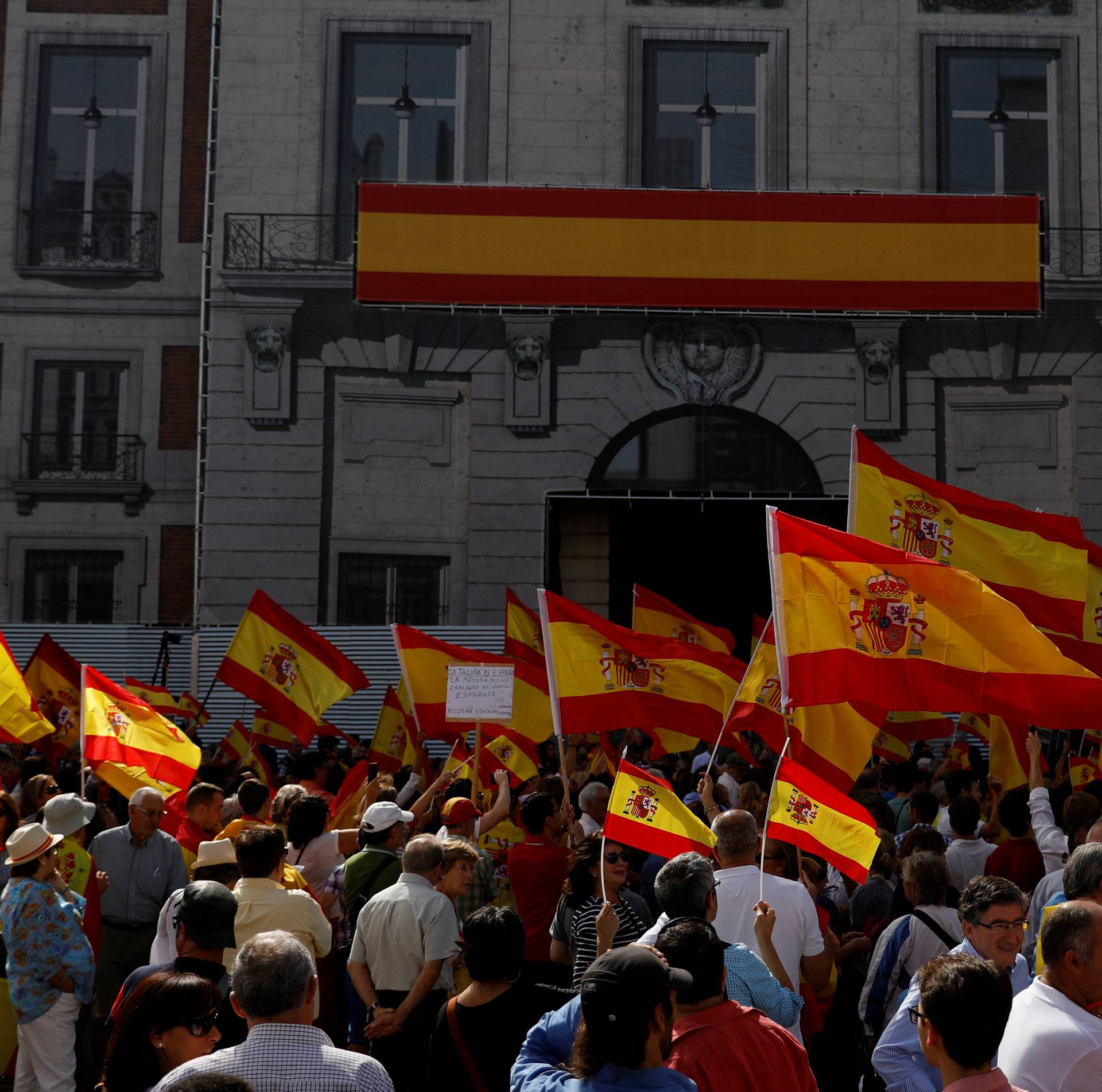 Demonstrators wave Spanish flags during a demonstration in favor of a unified Spain on the day of a banned independence referendum in Catalonia, in Madrid