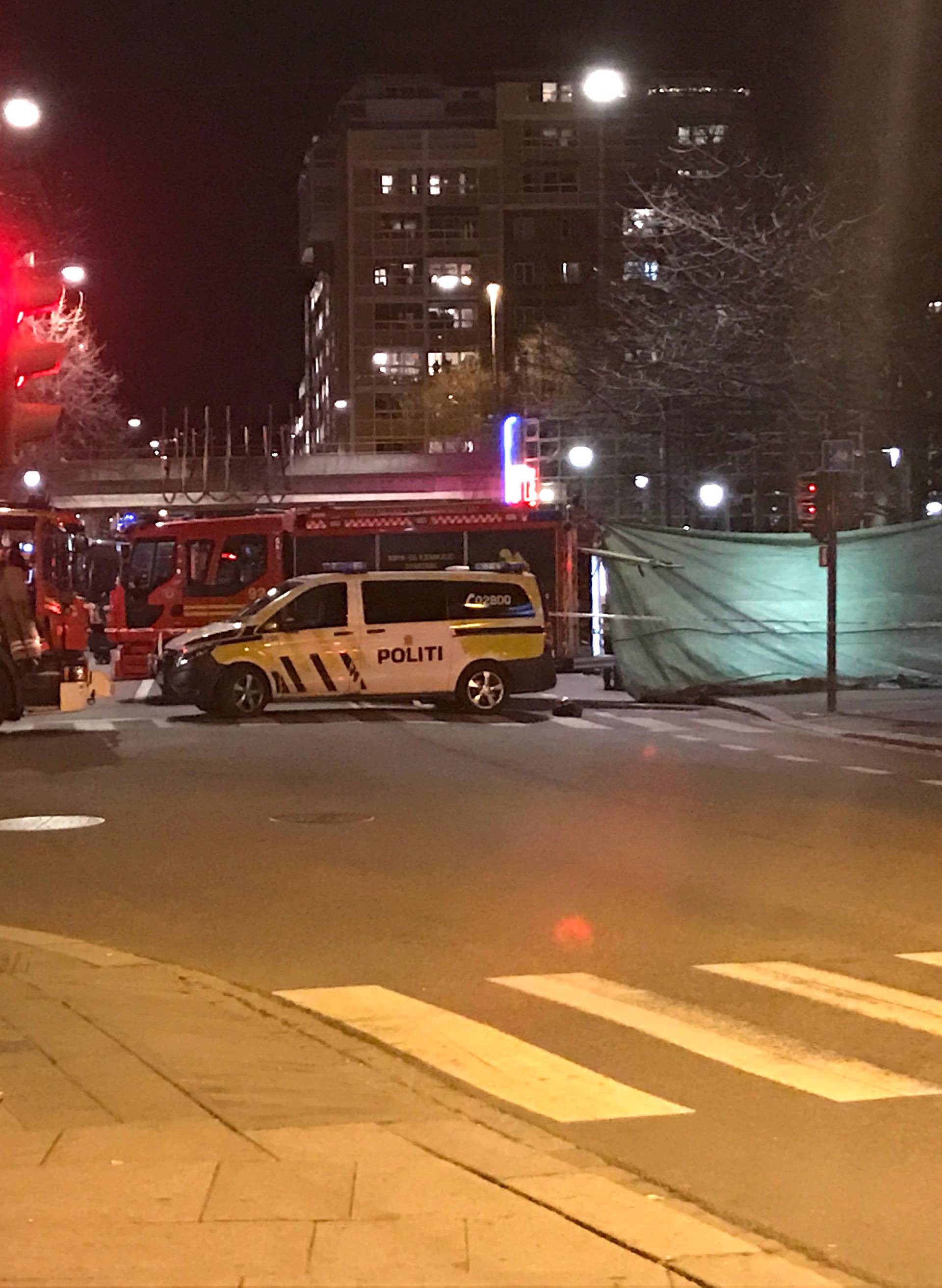 Rescue workers are seen in an area in central Oslo cordoned off by the police after the discovery of a "bomb-like device", in Oslo