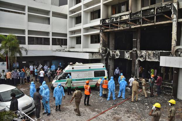 Rescue workers look for survivors after a fire broke out in a hotel that was being used as a COVID-19 facility in Vijayawada