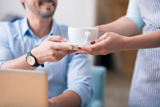 One female cafe worker giving coffee