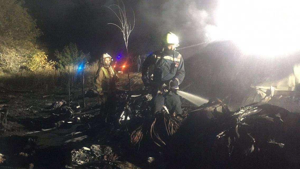 Rescuers work at the crash site of the Ukrainian military Antonov An-26 plane outside of Chuhuiv town