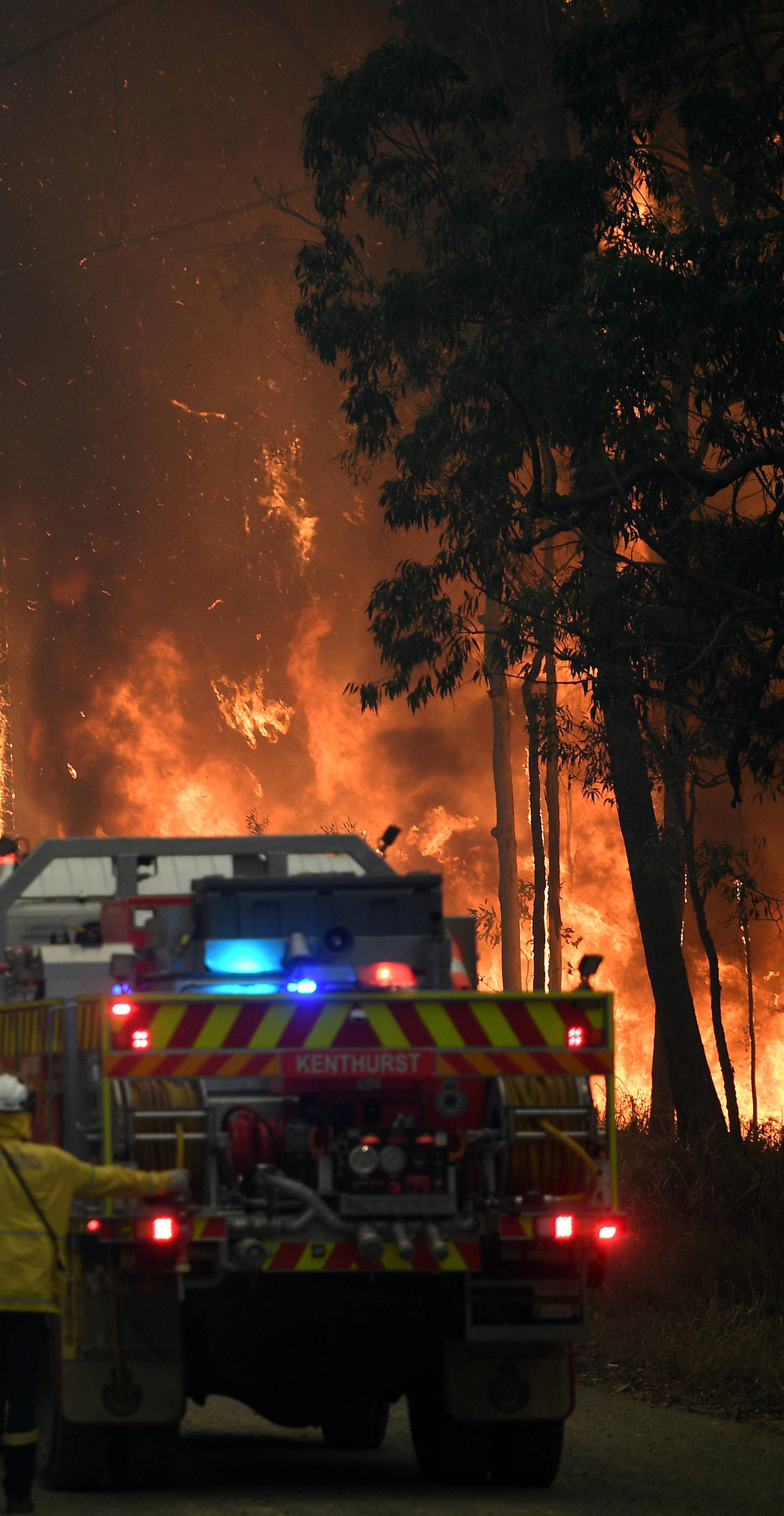 NSW Rural Fire Service crews fight a fire as it burns close to property on Wheelbarrow Ridge Road at Colo Heights, north west of Sydney