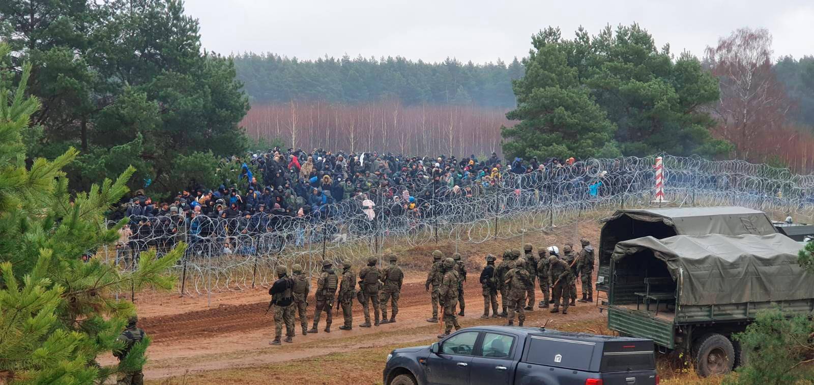 Polish Soldiers guard hundreds of migrants at the Polish/Belarus border near Kuznica Bialostocka