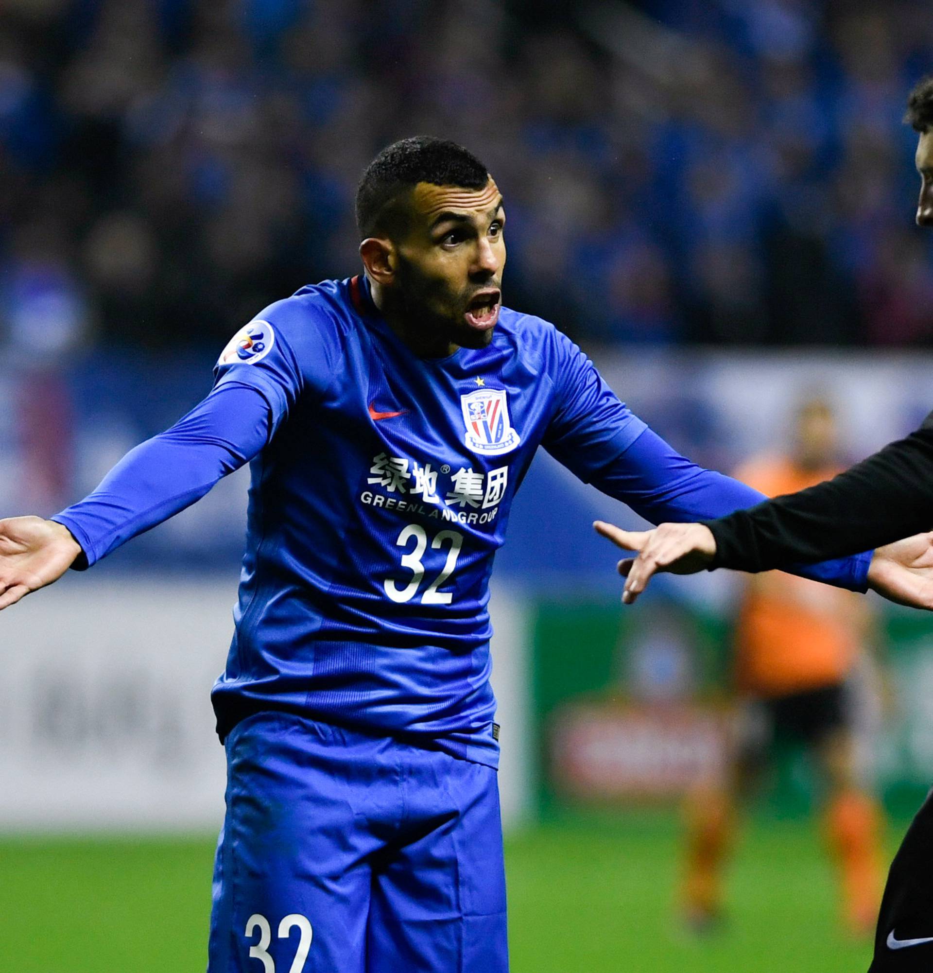 Shanghai Shenhua's Carlos Tevez reacts to a referee during the AFC Champions League 2017 play-off match between Shanghai Shenhua and Brisbane Roar in Shanghai