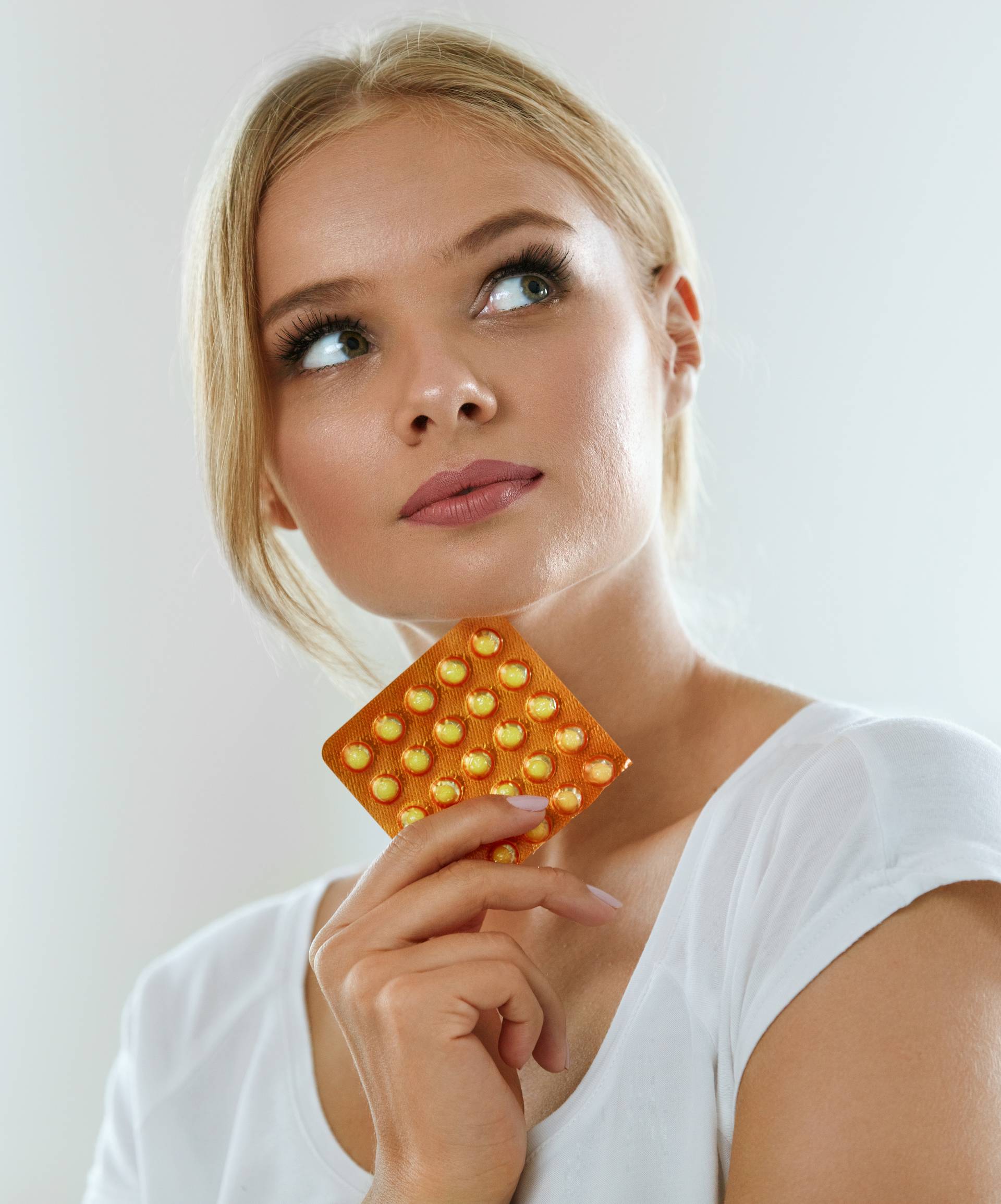Beautiful Woman Holding Birth Control Pills, Oral Contraceptive