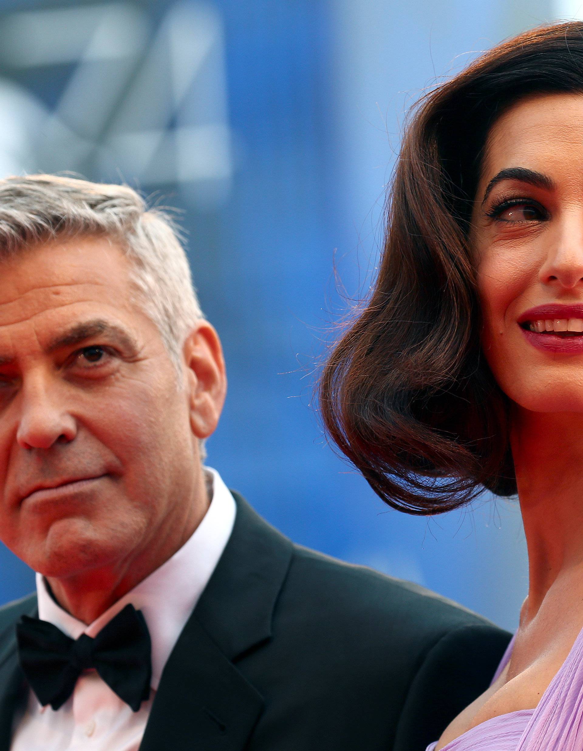 Actor and director George Clooney and his wife Amal pose during a red carpet event for the movie "Suburbicon" at the 74th Venice Film Festival in Venice, Italy