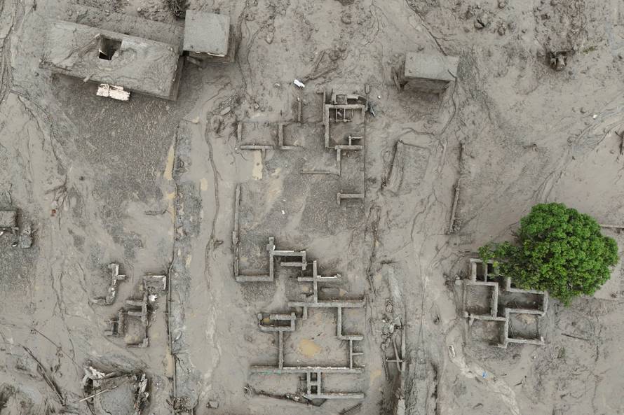 A drone view shows mud covering buildings following a flash flood in Trishuli