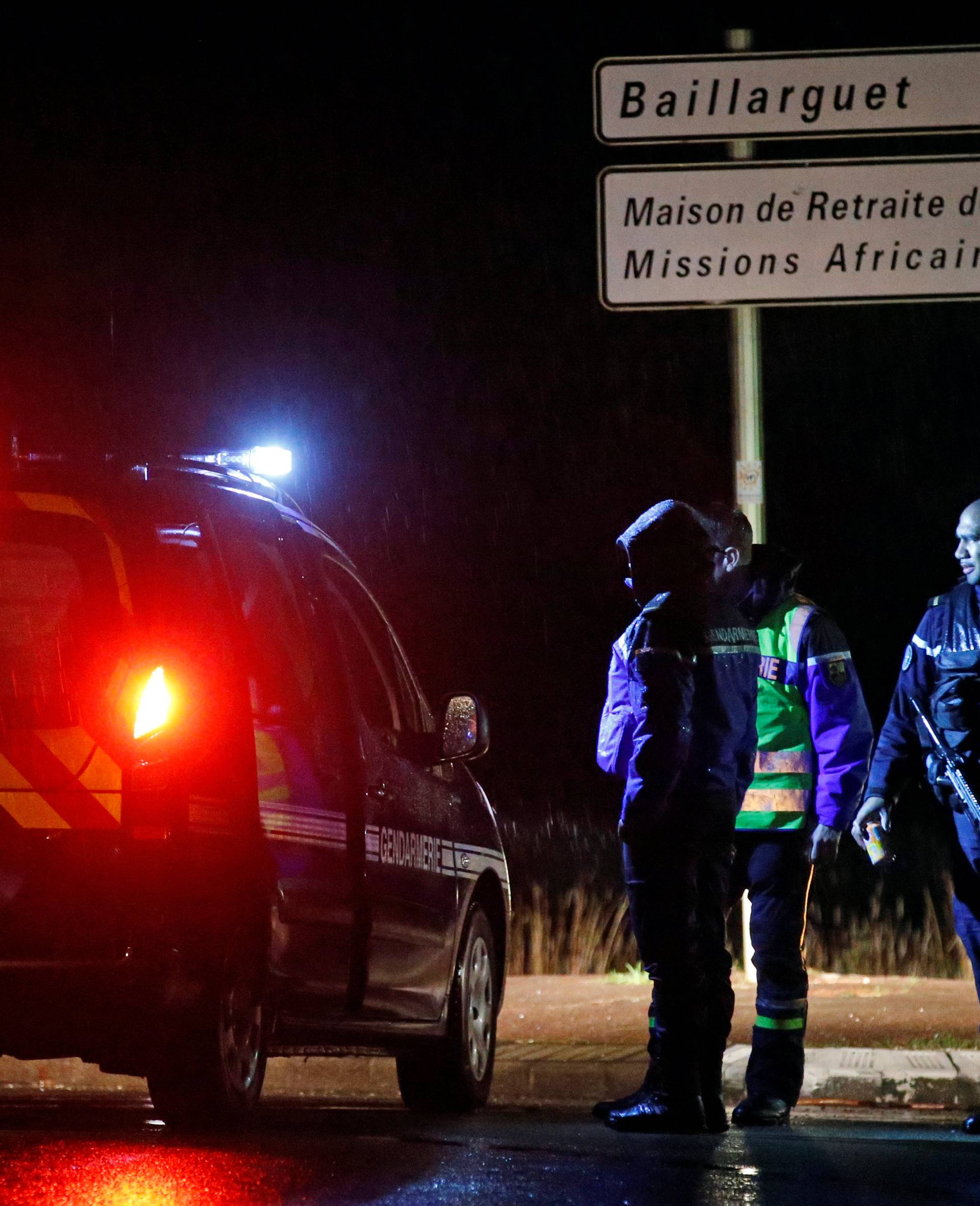 French gendarmes stand guard near a retirement home in Montferrier-sur-Lez, near Montpellier