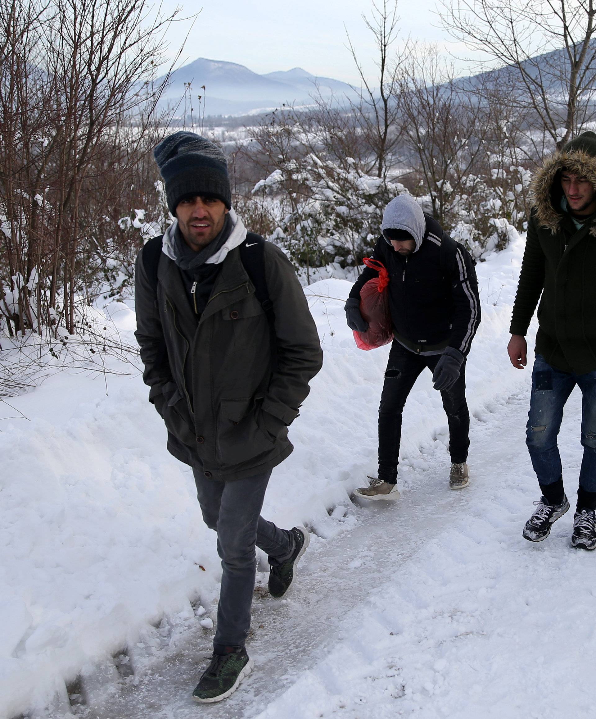 A group of migrants attempts to illegally cross the border into Croatia on the Pljesevica Mountain near Bihac