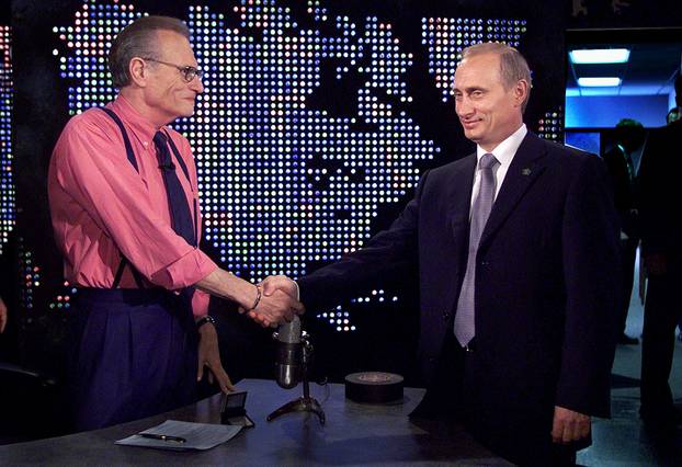 FILE PHOTO: Putin shakes hands with Larry King before taping of "The Larry King Show" in New York