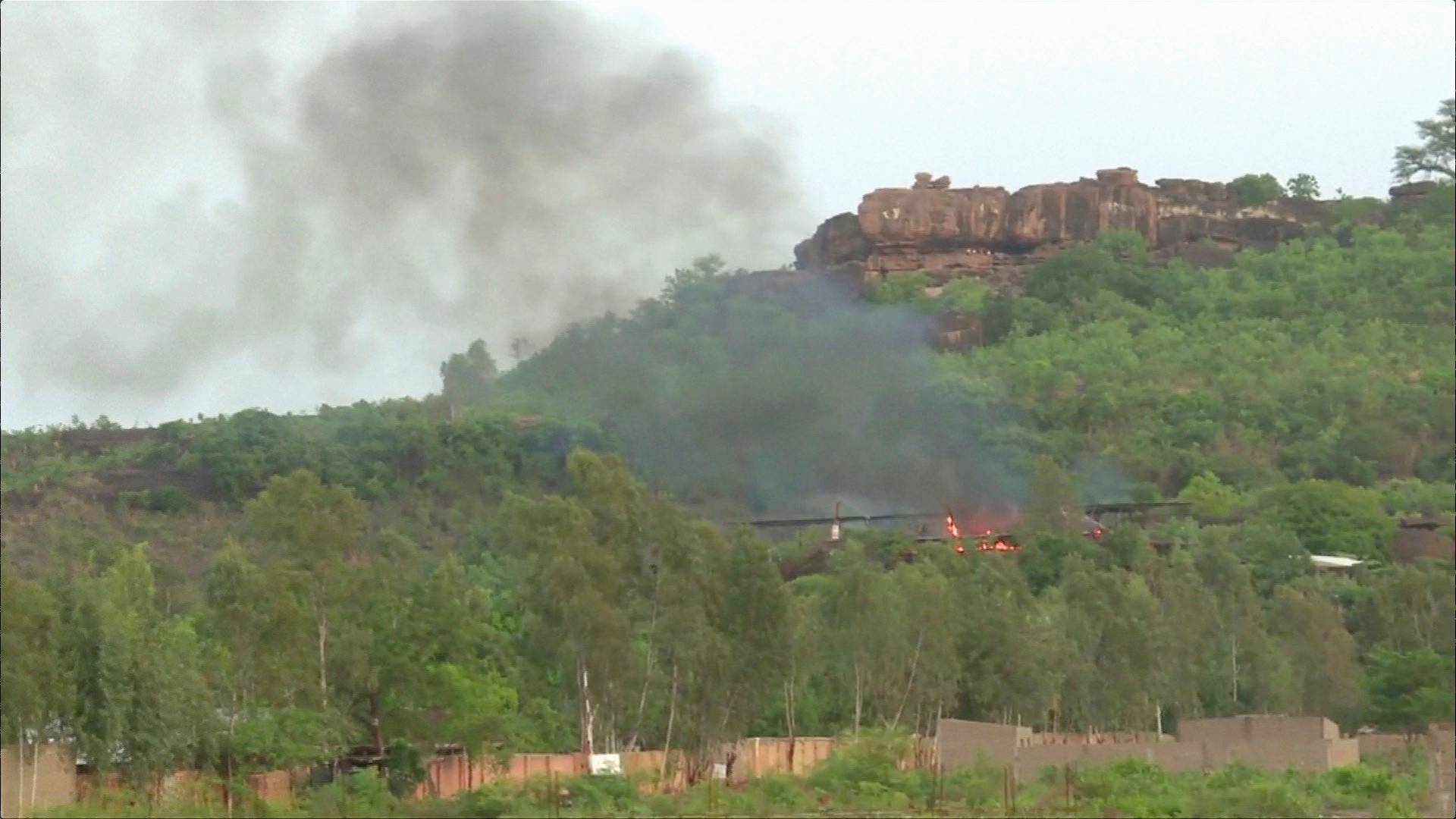 Flames rise following an attack where gunmen stormed Le Campement Kangaba resort in Dougourakoro, to the east of the capital Bamako, Mali in this still frame taken from video