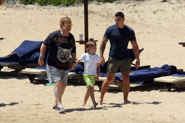 Elton John and David Furnish reaching the beach with kids