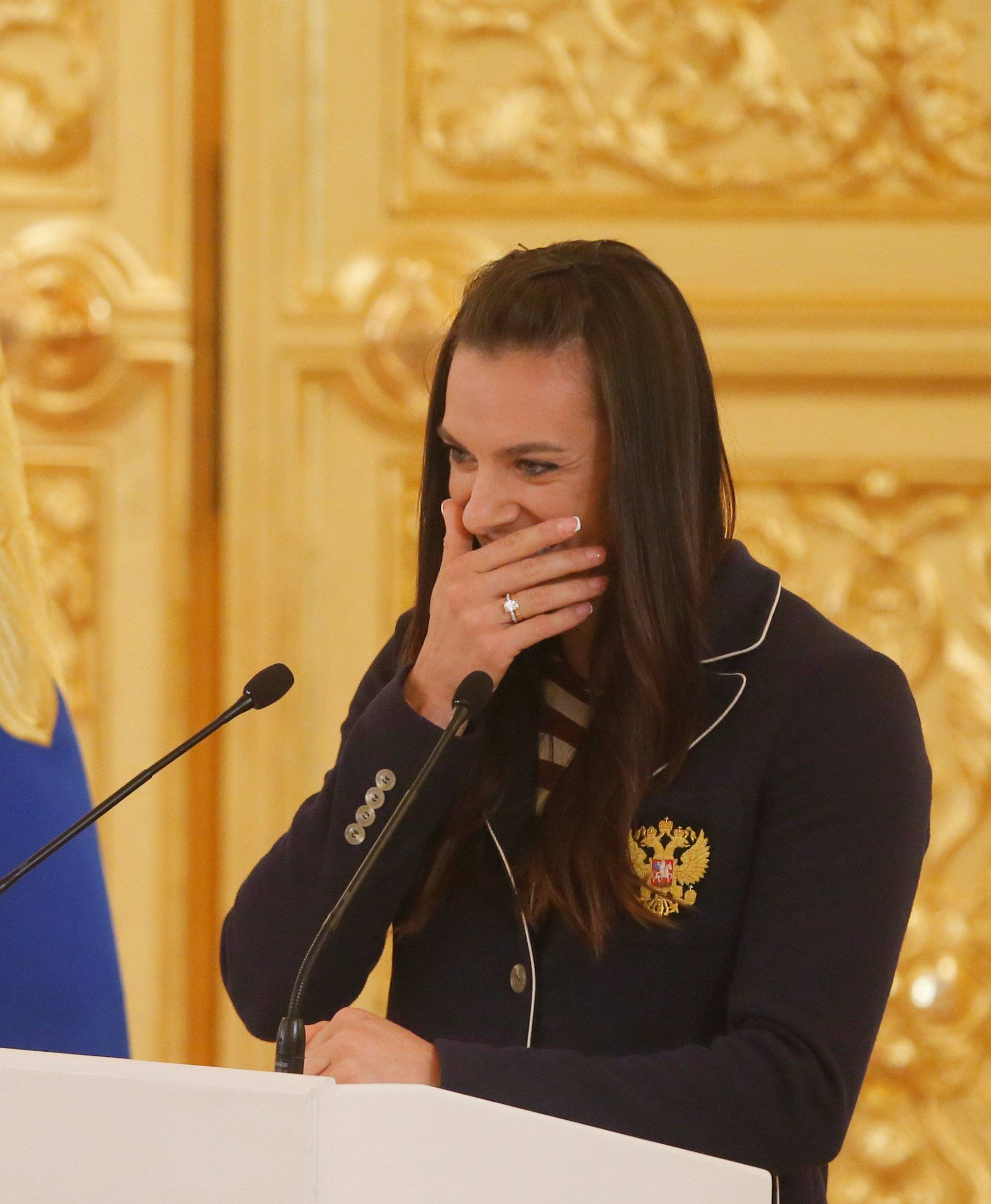 Track-and-field athlete Isinbayeva reacts as she speaks during Russian President Putin's personal send-off for members of Russian Olympic team at Kremlin in Moscow