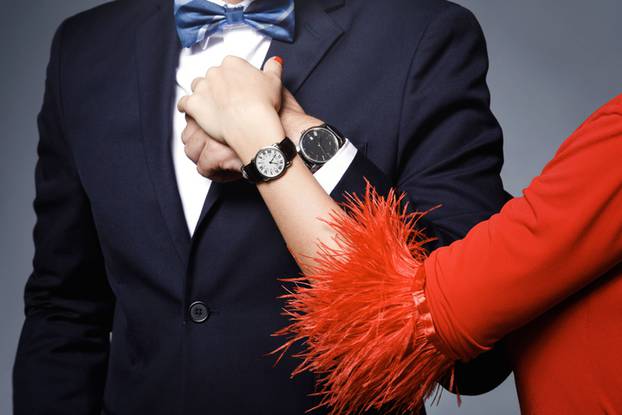 Well dressed stylish couple wearing wristwatches