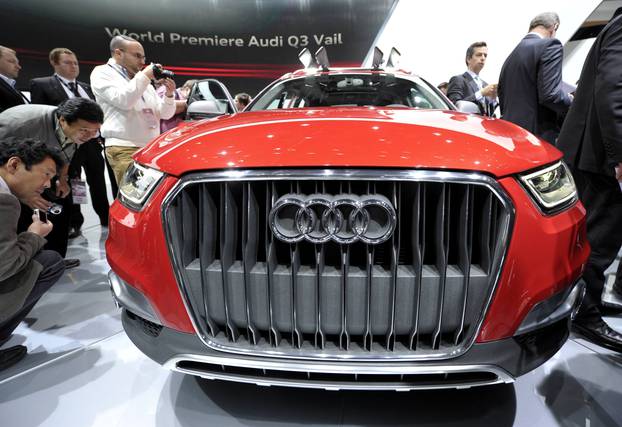 Members of the media get a close-up view of the Audi Q3 Vail during the first press preview day for the North American International Auto Show in Detroit