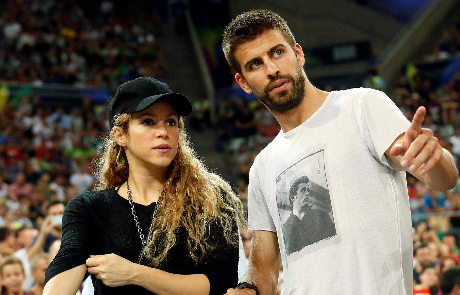 FILE PHOTO: Colombian singer Shakira and her partner, Barcelona soccer player Pique, attend the Basketball World Cup quarter-final game between the U.S. and Slovenia in Barcelona