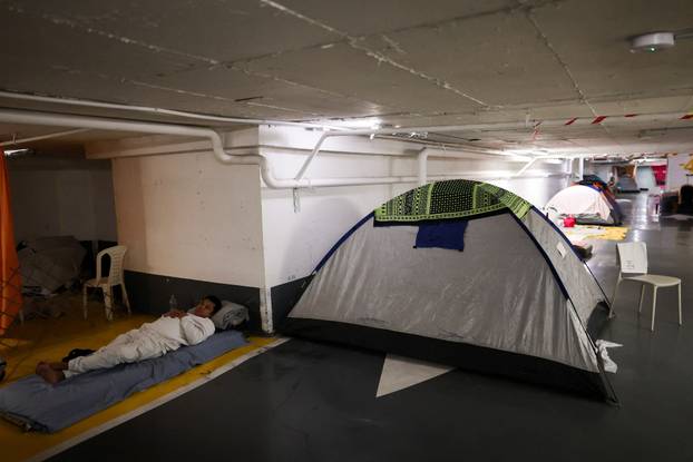 Israelis hold a Passover Seder in an underground parking garage used as a public bomb shelter, in Tel Aviv