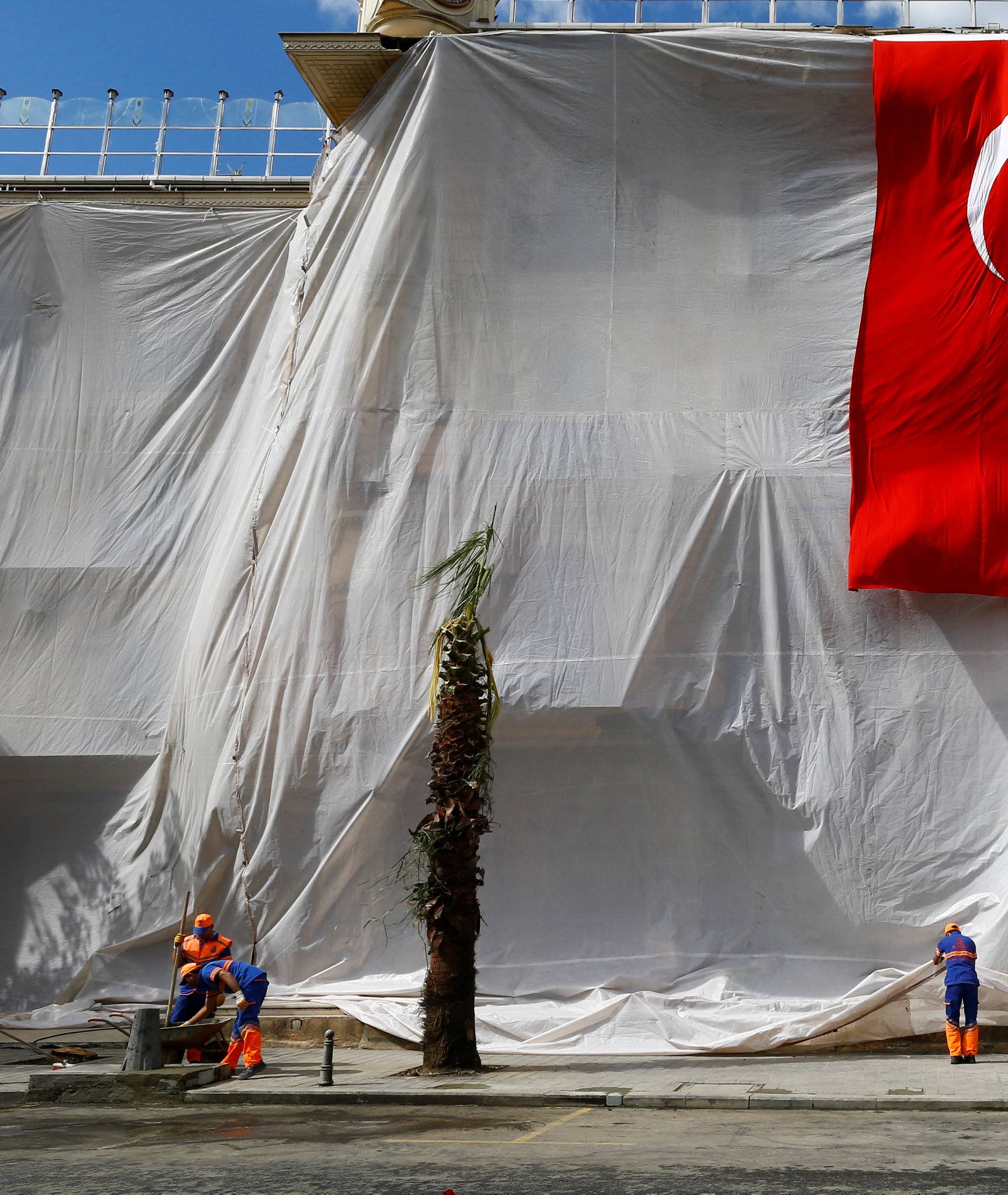 A building is seen covered and decorated with a Turkish flag after Tuesday's car bomb attack on a police bus, in Istanbul