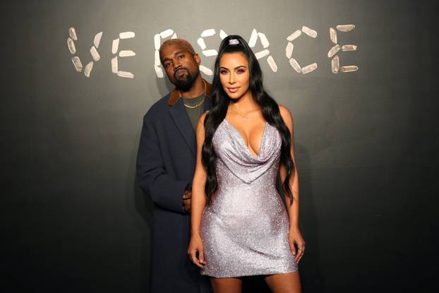 Kanye West and Kim Kardashian pose for a photo before attending the Versace presentation in New York