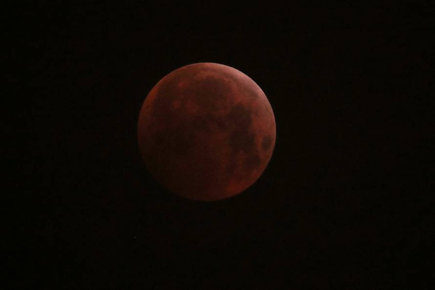 The moon is seen during a lunar eclipse in Paris
