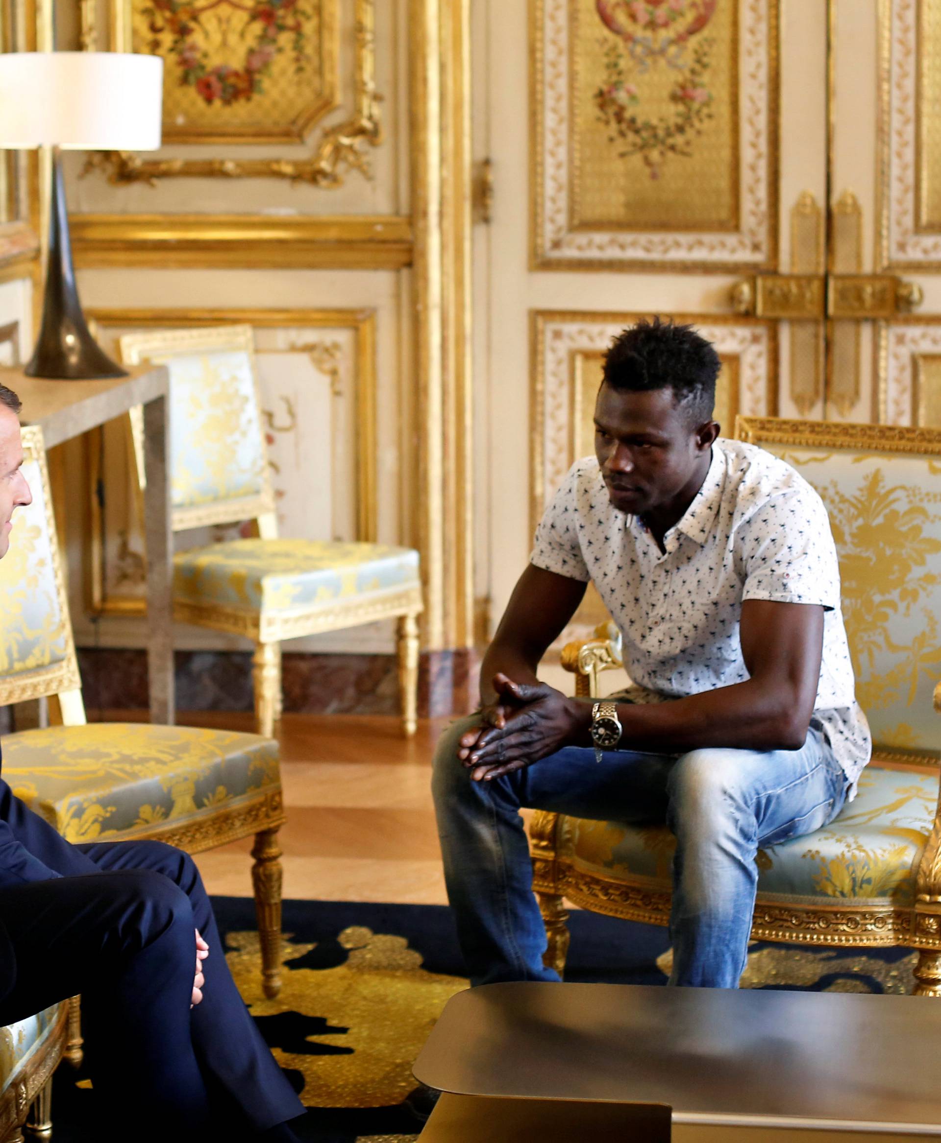 French President Emmanuel Macron meets with Mamoudou Gassama, 22, from Mali, at the Elysee Palace in Paris