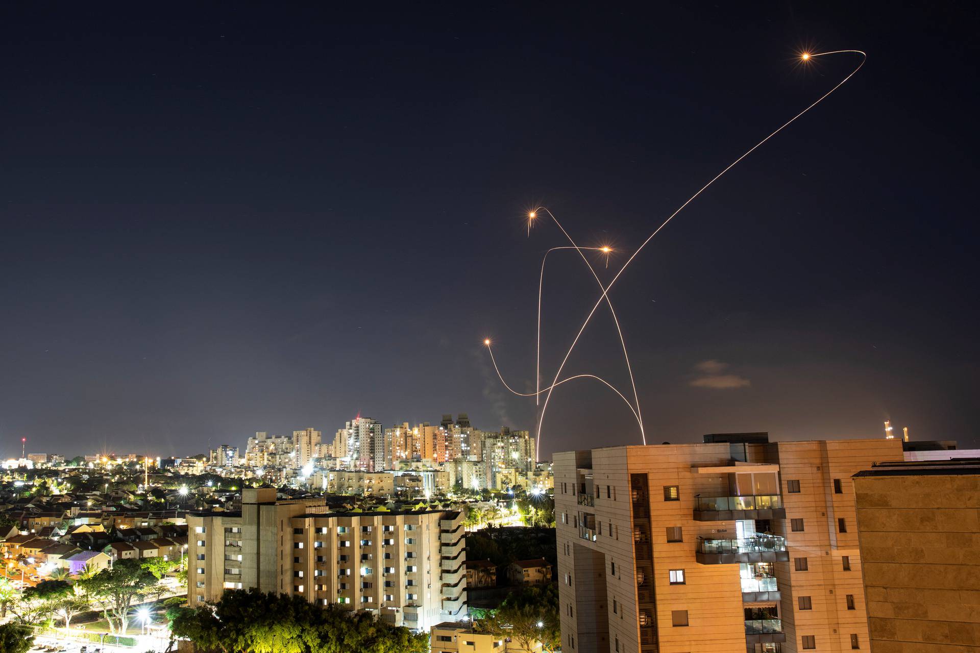 Streaks of light are seen as Israel's Iron Dome anti-missile system intercepts rockets launched from the Gaza Strip towards Israel, as seen from Ashkelon, Israel