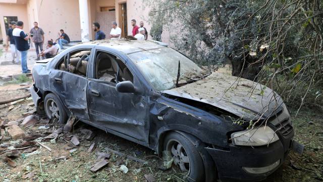 A damaged car is seen during clashes between rival factions in Tripoli, Libya