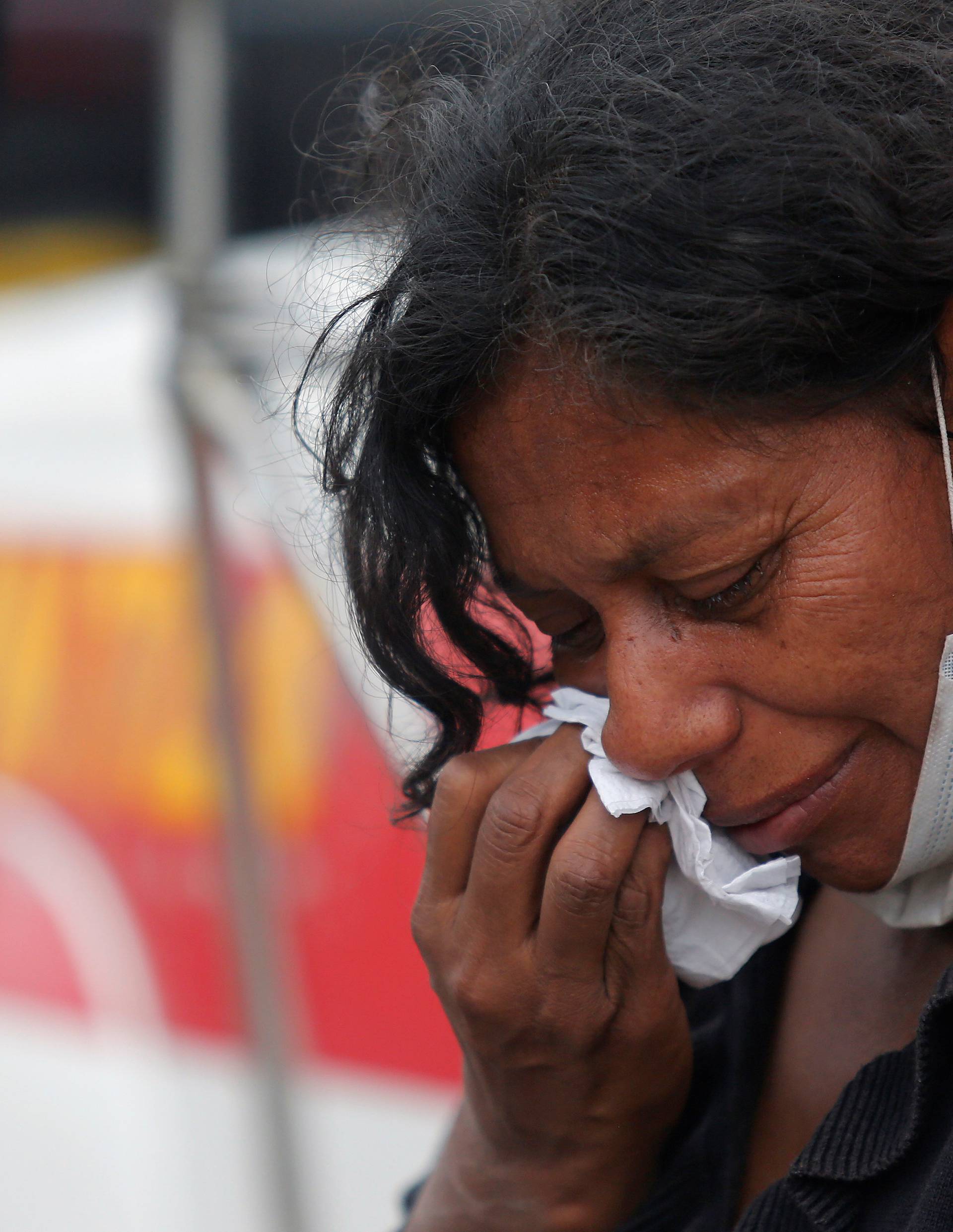 A woman mourns for her missing relatives at an area affected by eruption from Fuego volcano in Escuintla