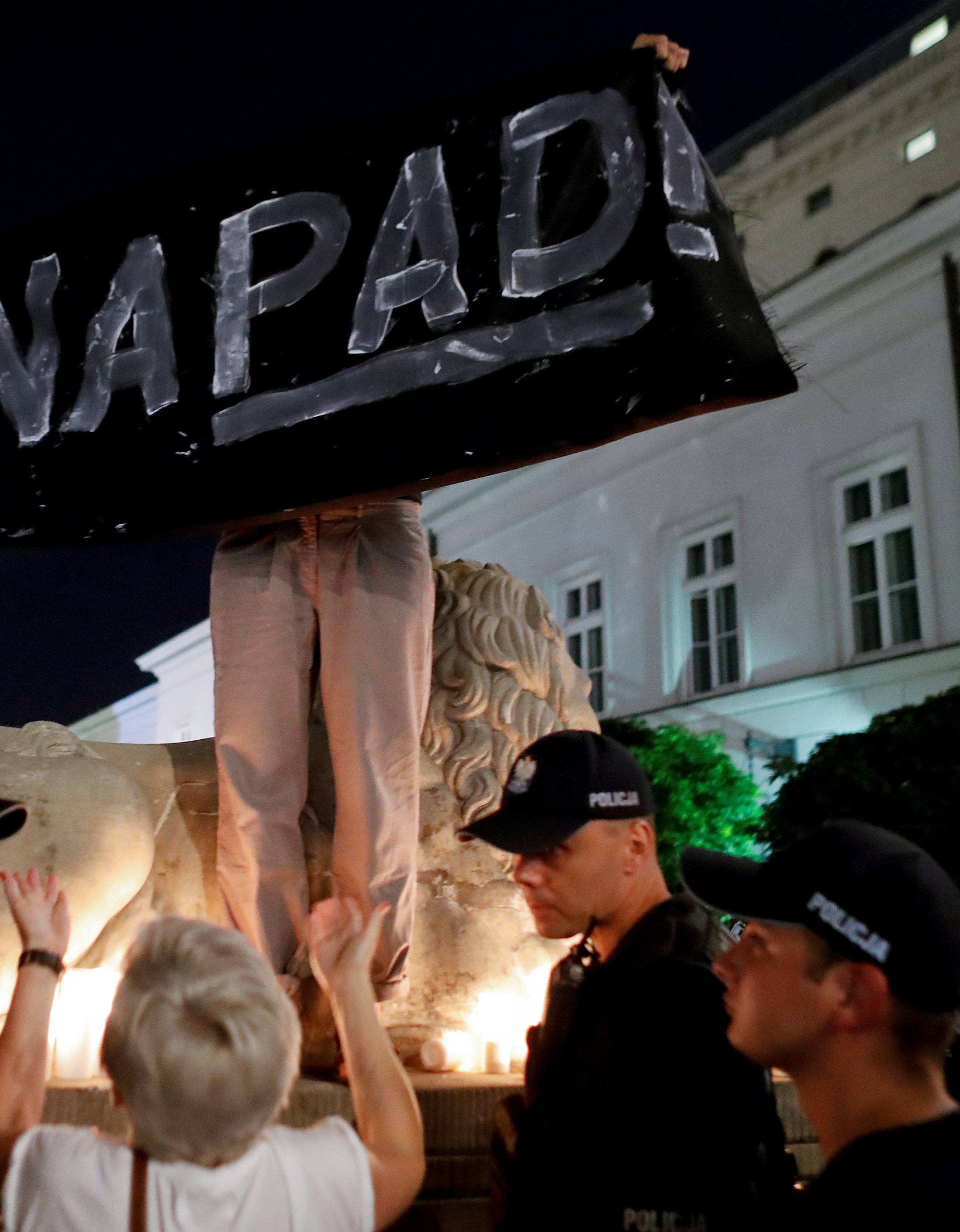 People attend the "Chain of lights" protest against judicial overhaul in front of the Presidential Palace in Warsaw