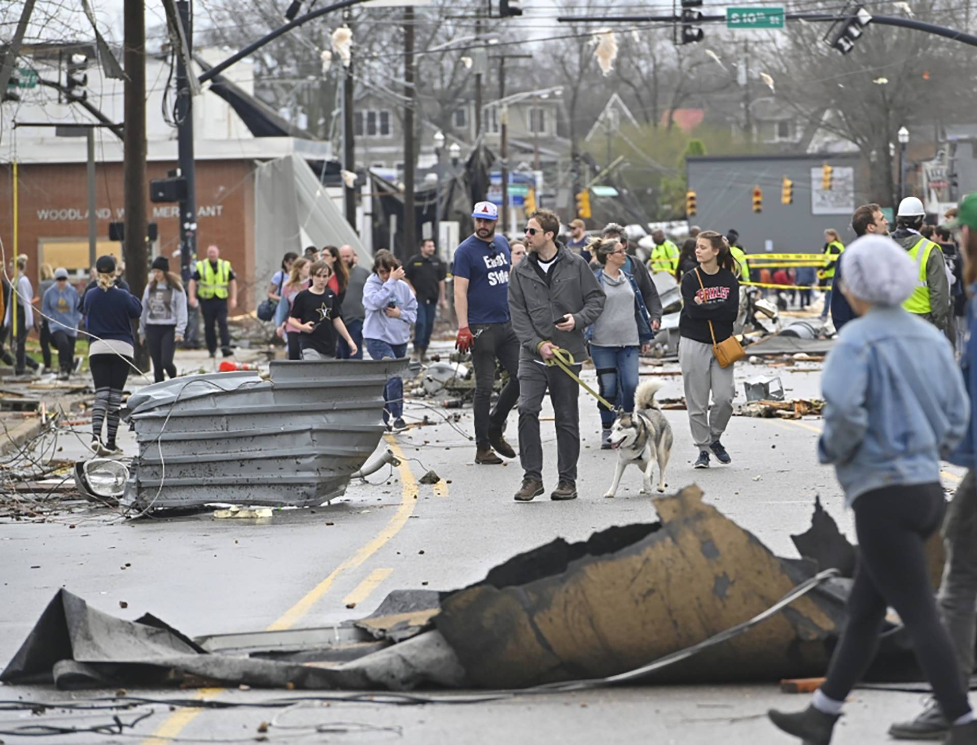 People view damage along Woodland Street after a tornado touched down in Nashville