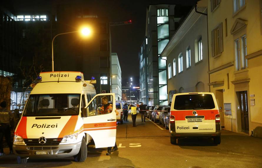 Police stand outside an Islamic center in central Zurich