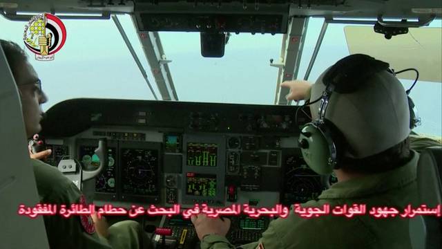 An Egyptian pilot points during a search operation by Egyptian air and navy forces for the EgyptAir plane that disappeared in the Mediterranean Sea, in this still image taken from video