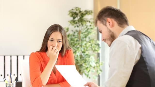 Nervous,Woman,Looking,At,Manager,Reading,Her,Resume,During,A