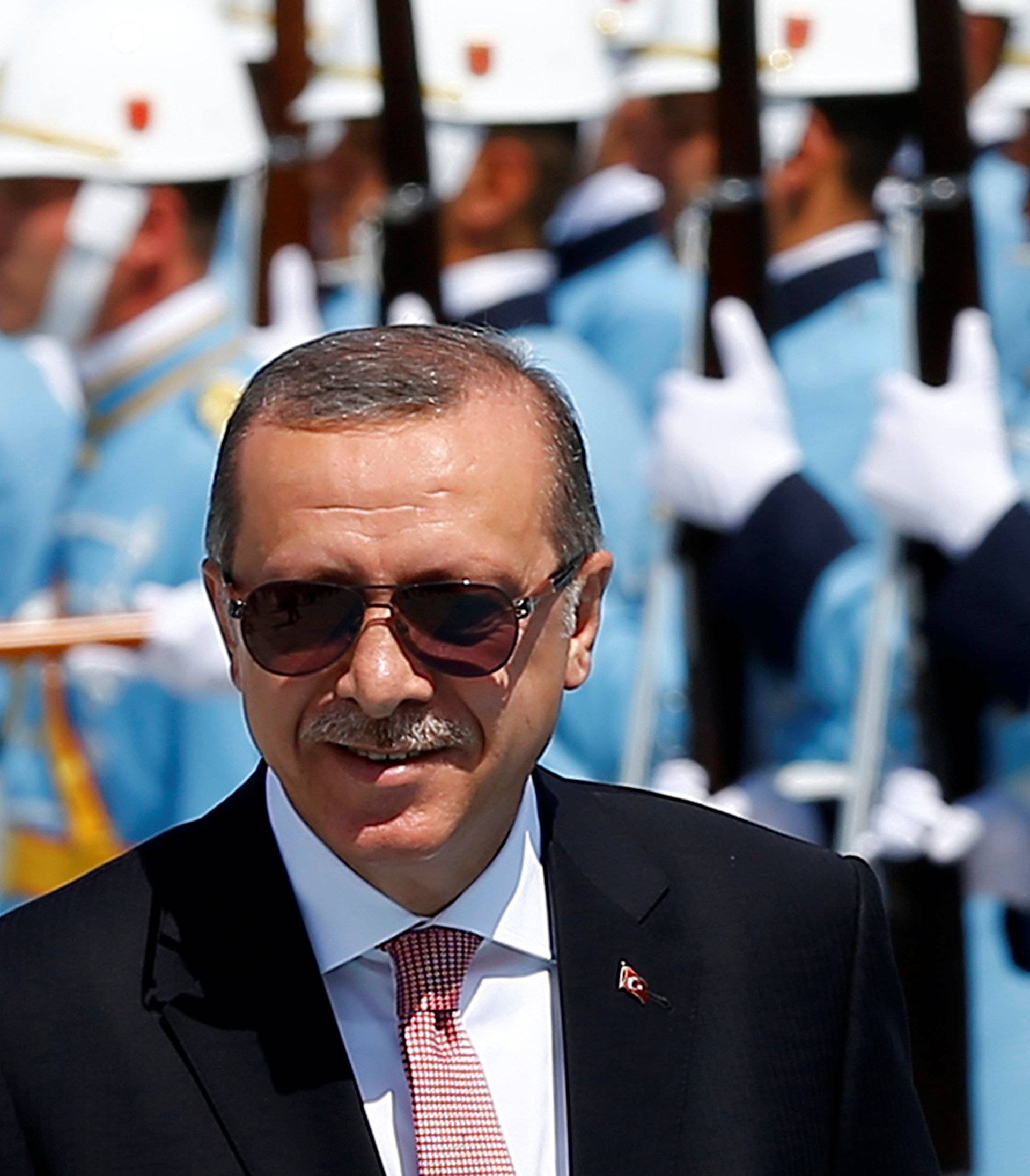 Turkish President Tayyip Erdogan reviews a guard of honour during a welcoming ceremony at the Presidential Palace in Ankara