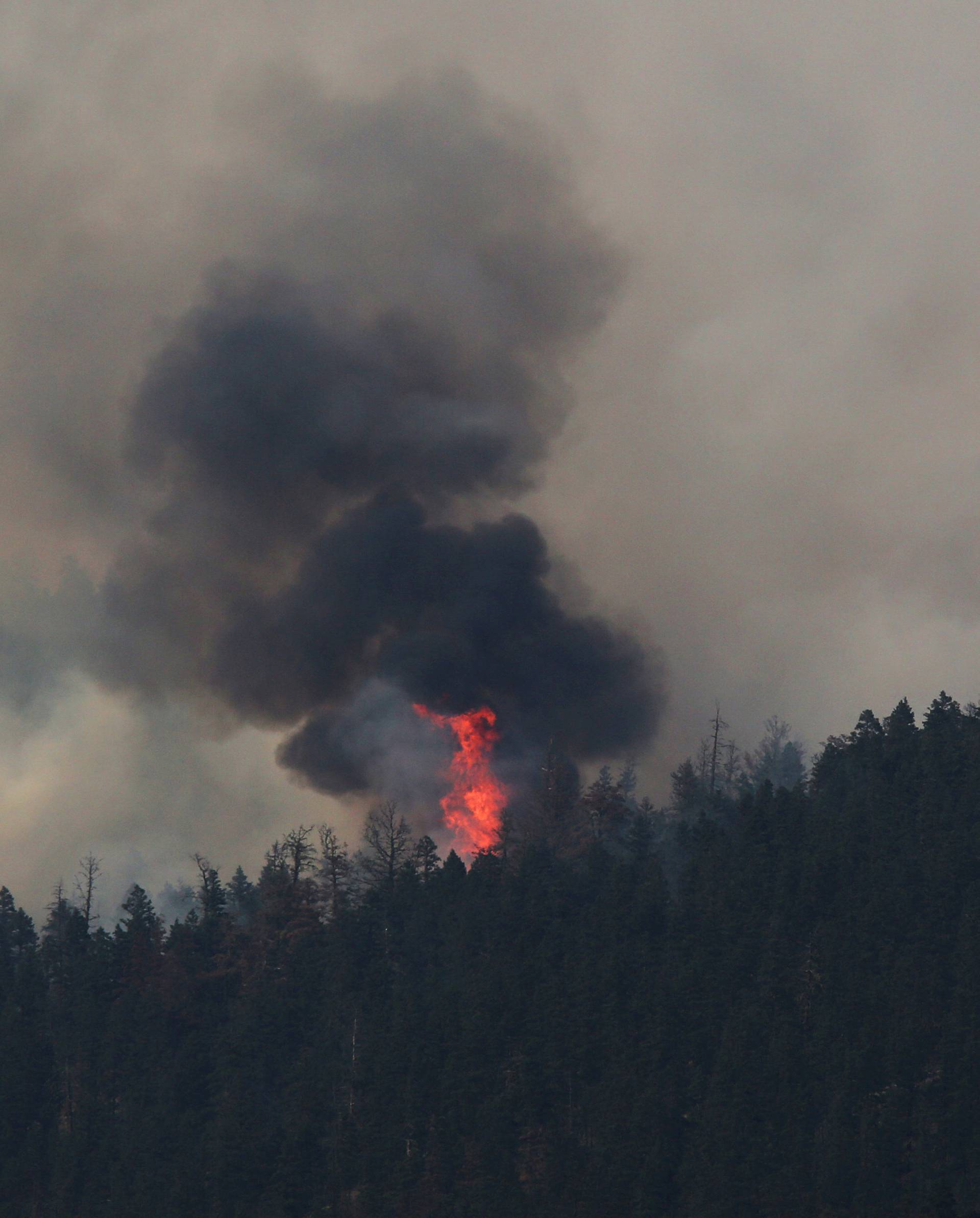 FILE PHOTO - A wildfire burns north east of the town of Cache Creek