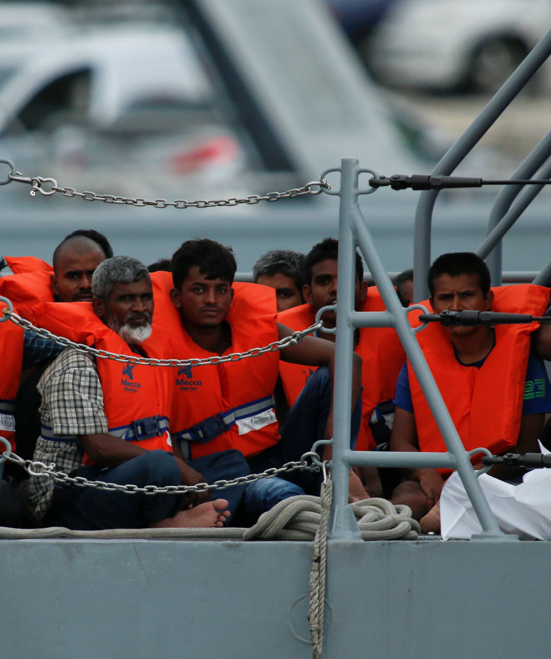 Rescued migrants are seen on board of a patrol boat as they enter Marsamxett Harbour, Valletta