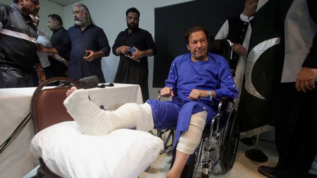 Former Pakistan's Prime Minister Imran Khan sits in a wheelchair after he was wounded following a shooting incident on a long march in Wazirabad, at the Shaukat Khanum Memorial Cancer Hospital & Research Centre in Lahore