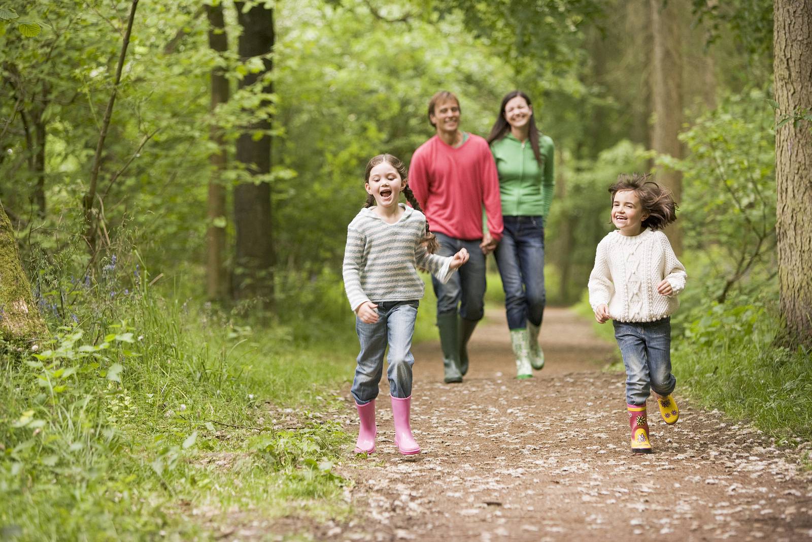 Families Walking On Path Holding Hands Smiling