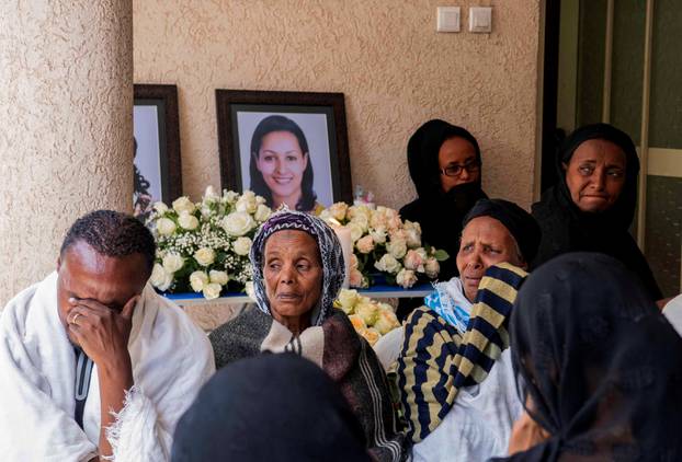 Relatives and friends of Sara Gebremichael, a senior hostess and a crew leader on the Ethiopian Airlines Flight ET 302 plane that crashed, mourn at her house in Addis Ababa