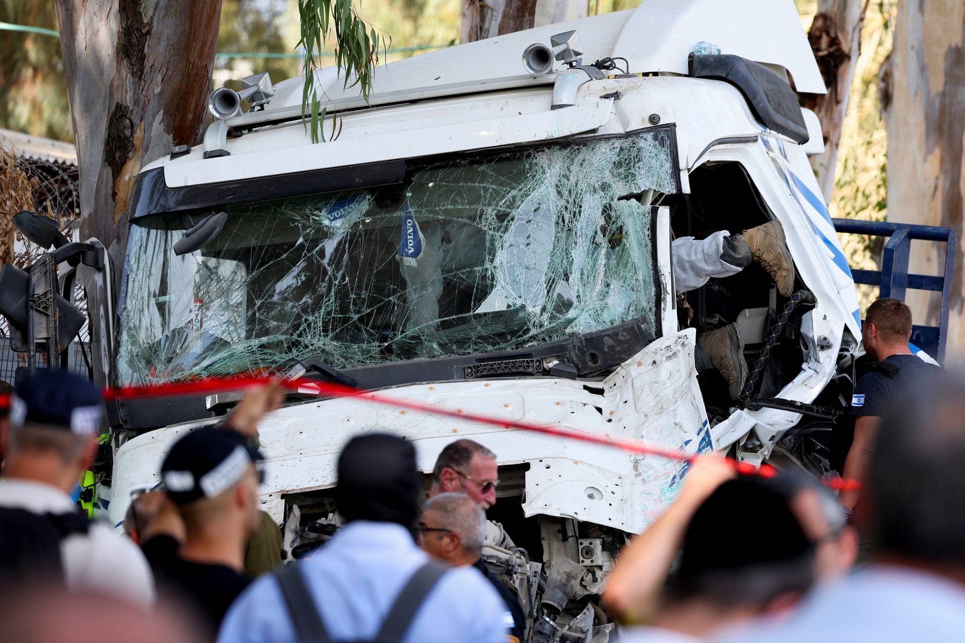 Israeli emergency services work at the scene where a truck rammed into pedestrians at a bus stop, in Ramat Hasharon