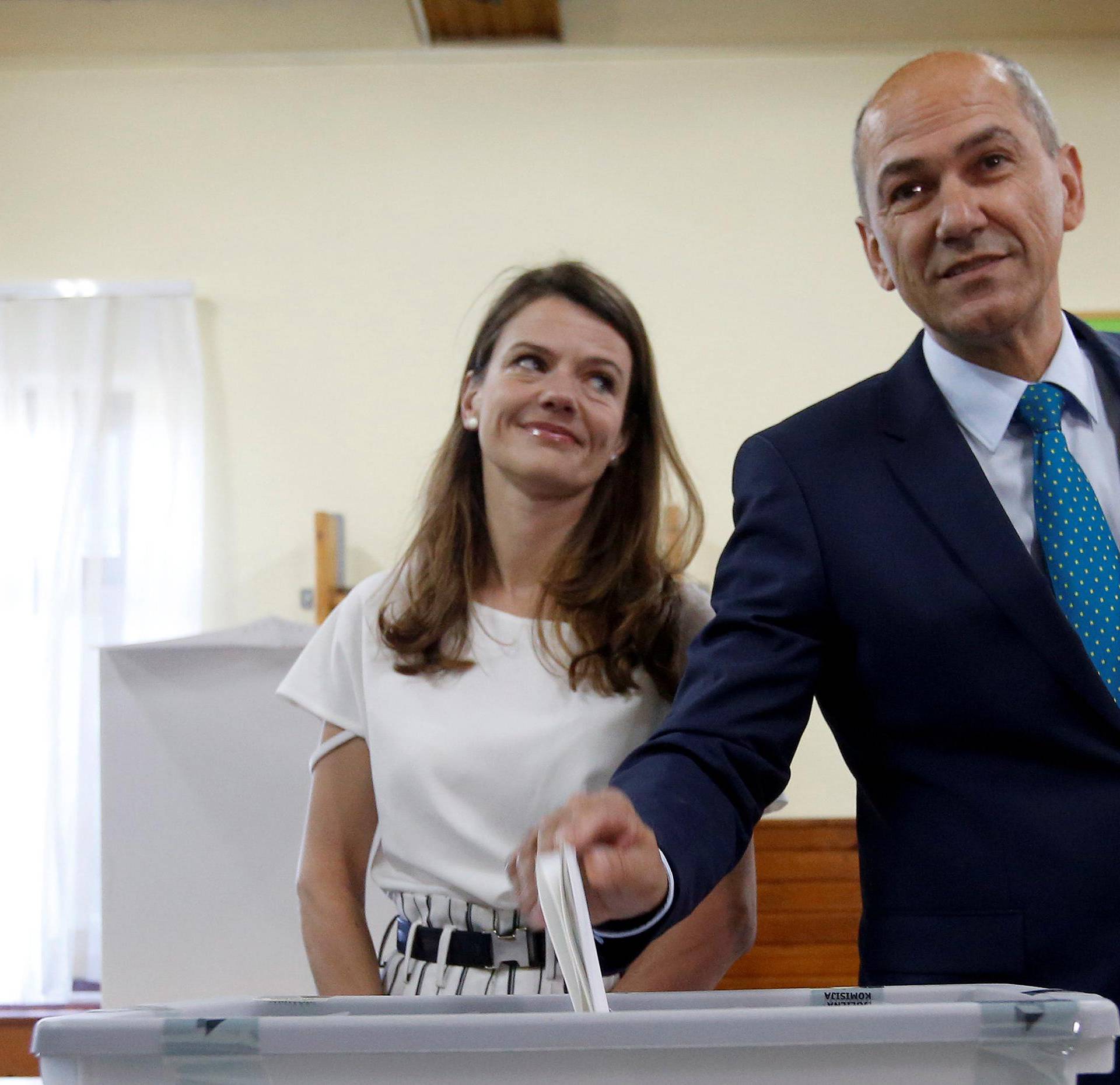 SDS leader Jansa and his wife cast their votes at a polling station during the general election in Velenje