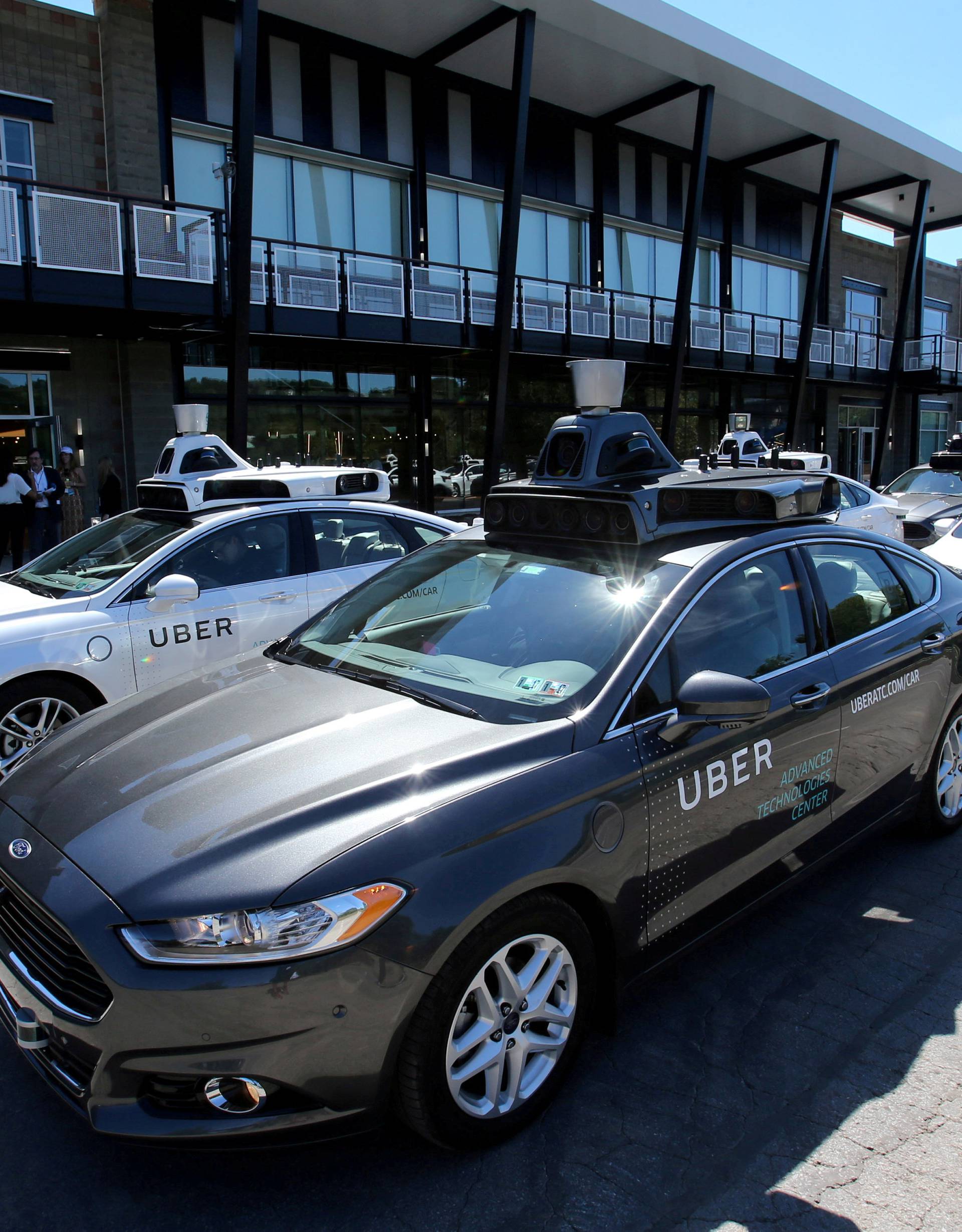 FILE PHOTO: A fleet of Uber's Ford Fusion self driving cars are shown during a demonstration of self-driving automotive technology in Pittsburgh