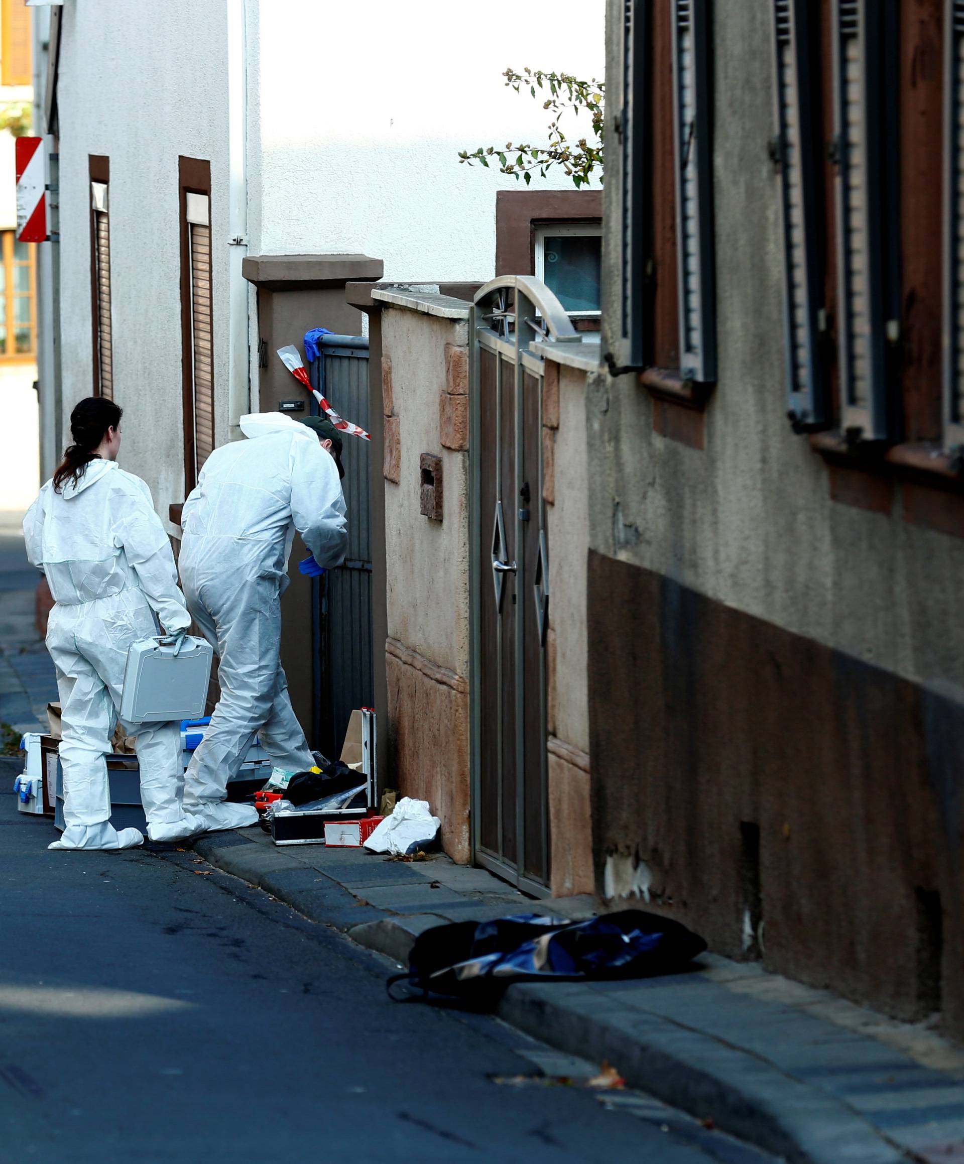 A forensic expert works at a crime scene where two people died during a police operation in Kirchheim