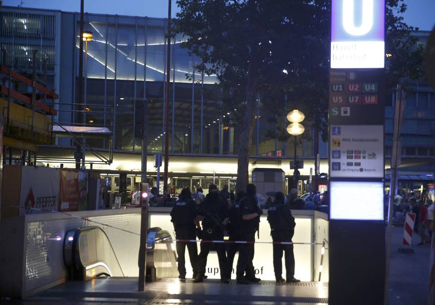 Special force police officers stand guard at entrance of main train station following shooting rampage at shopping mall in Munich