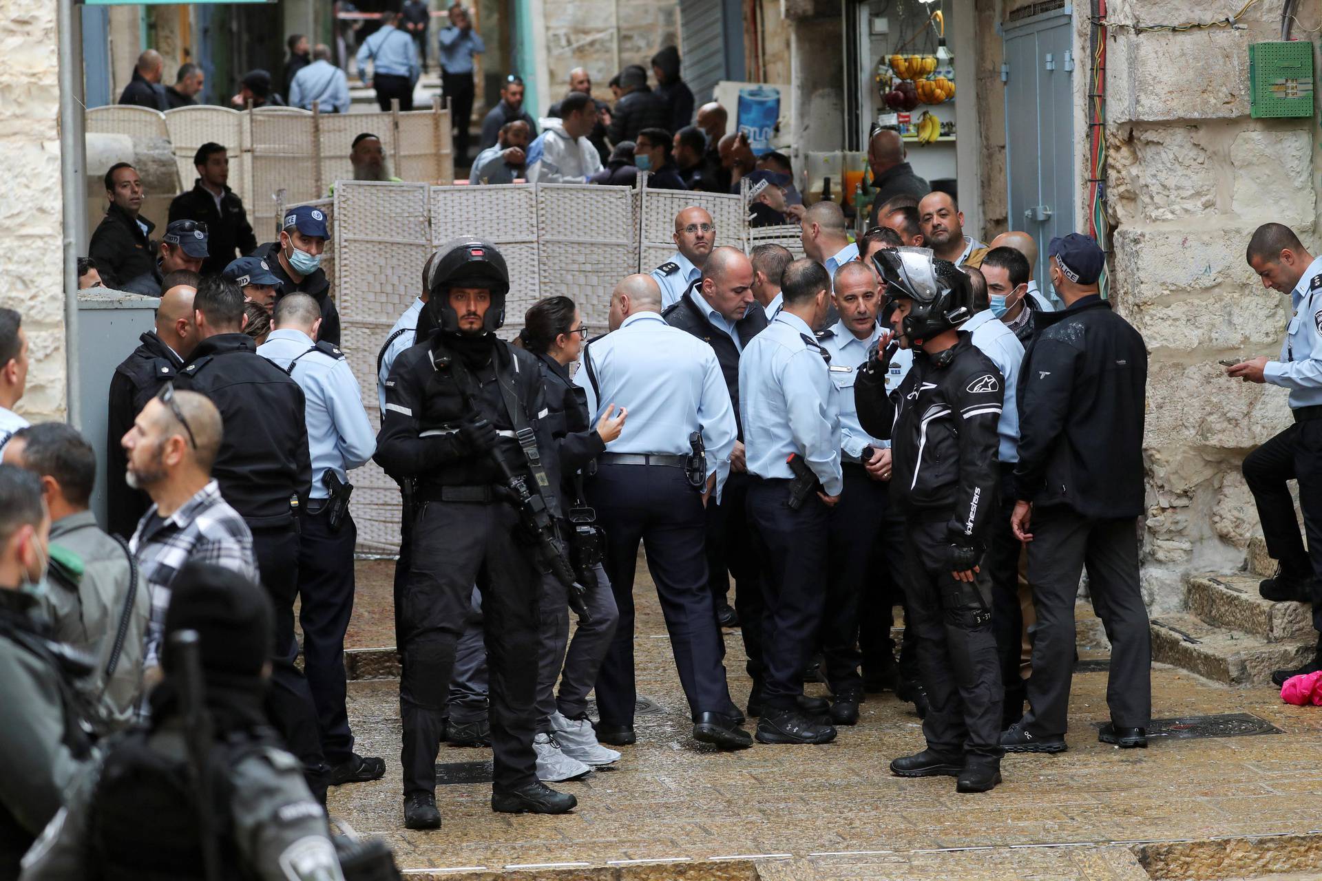 Top Israeli police officials gather near the site of a shooting incident in Jerusalem's Old City