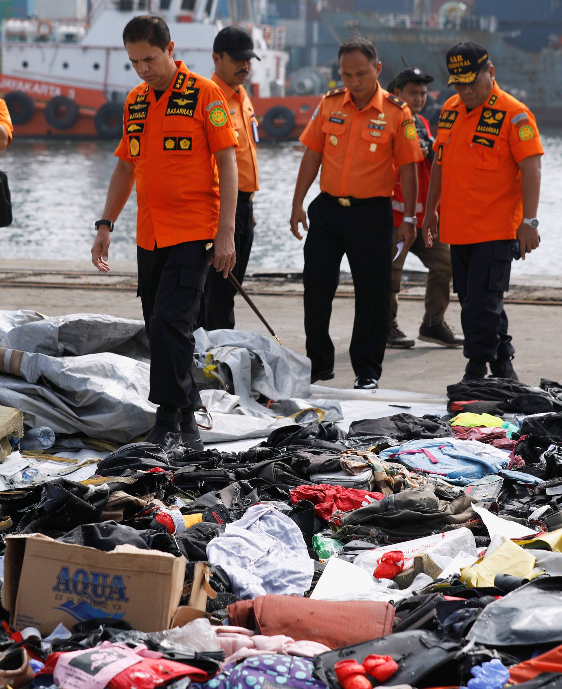 Chief of Indonesia's Lion Air flight JT610 search and rescue operations Muhammad Syaugi looks through recovered belongings believed to be from the crashed flight at Tanjung Priok port in Jakarta