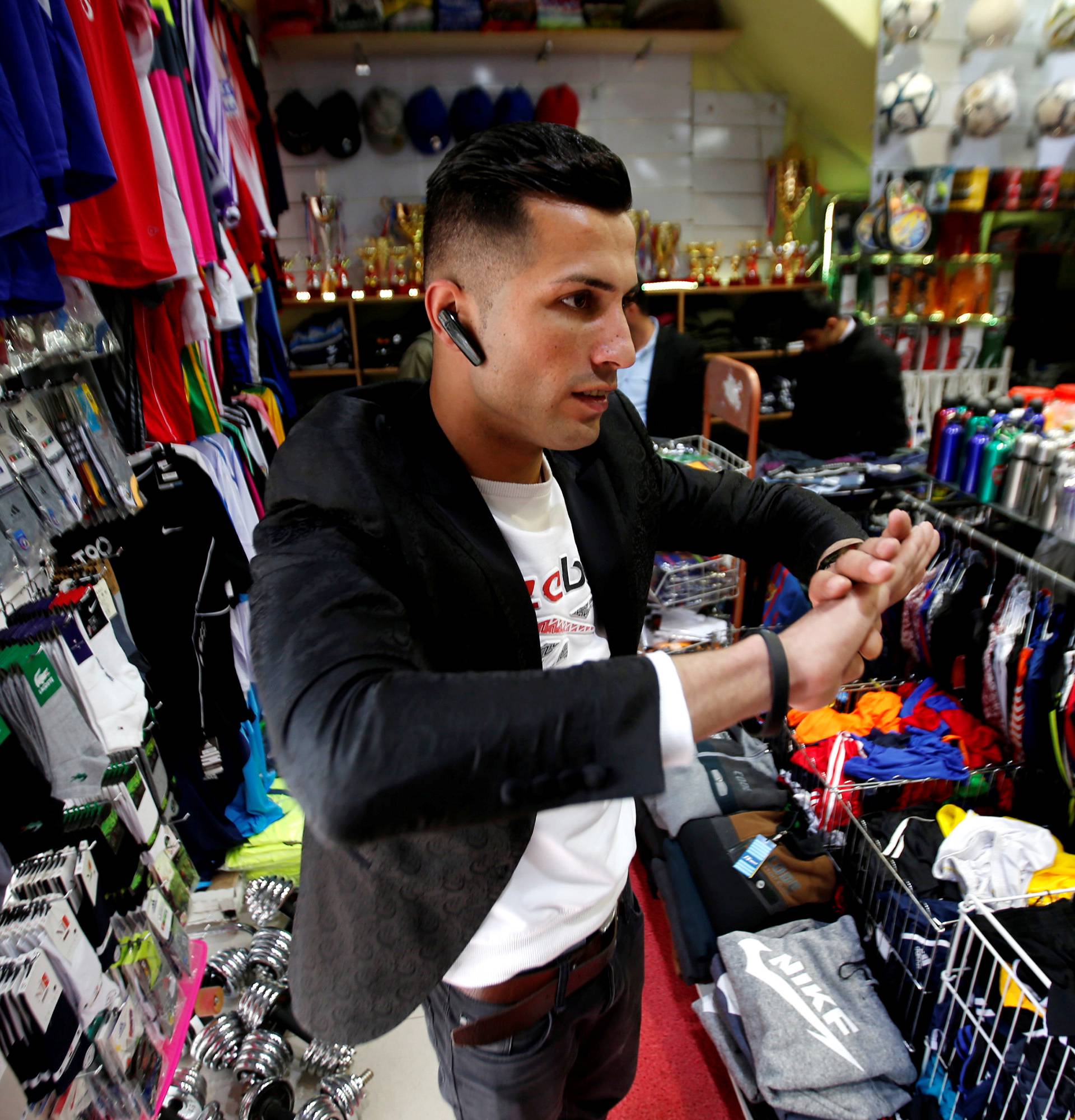 Biwar Abdullah, 25, an Iraqi Kurdish local footballer, who looks like the football player Cristiano Ronaldo, is seen at a sportswear shop in the district of Soran, northeast of Erbil